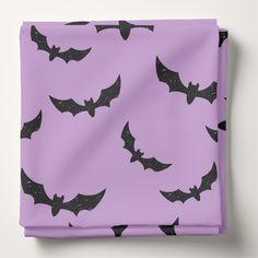 a purple background with black bats on it