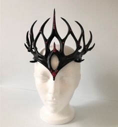 DESCRIPTIONGorgeous red Swarovski crystals make this magnificent glossy black Crown of Thorns emanate power, magic and royalty! Cosplay a good queen who is drawn to black, or an evil one who is drawn to dark magic. Any Queen, King, Prince or Princess flaunting this headpiece will provoke envy & admiration! Unisex: for God or Goddess, Sorceror or Sorceress, of any realm. Available in any color - with or without stones of any color - this lightweight leather crown is adjustable and waterproofe Evil King Crown, Dark Crowns Aesthetic King, Headpiece Jewelry Goddesses, Crowns For Queens, Evil Outfits Aesthetic, Feather Crown Diy, Pagan Headpiece, Dark Fairy Queen, Obsidian Crown