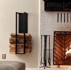 a fire place in a living room next to a couch and fireplace with logs on it