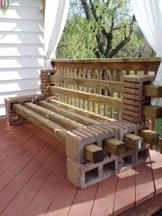 a wooden bench sitting on top of a hard wood floor next to a white house