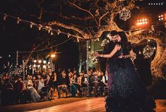 a couple dancing on the dance floor in front of an audience