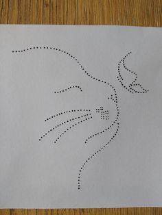 a piece of paper with a bird drawn on it's side and dots in the middle