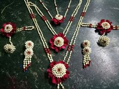 several necklaces with flowers and beads on a table