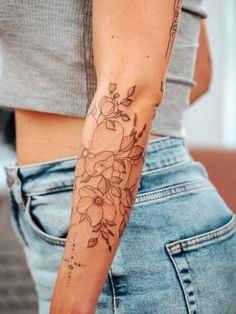 a woman with a flower tattoo on her arm