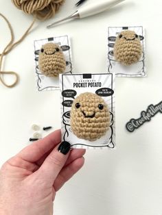 someone is holding up some crocheted items to make them look like they are smiling