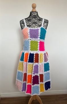 a crocheted dress is displayed on a mannequin