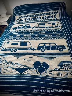 a blue and white crocheted blanket with cars on the road again written across it