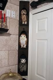 three shelves with owl figurines on them in a bathroom next to a door