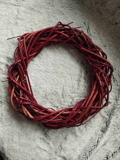 a close up of a wreath made out of twigs on top of a white blanket