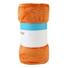 an orange and blue blanket sitting on top of a white surface with the word wow written on it