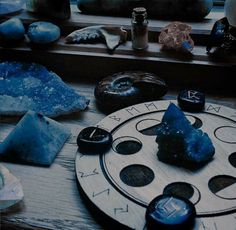 there are many different types of rocks and stones on the table, including one blue rock