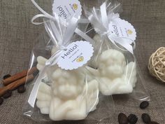 two bags filled with white chocolate sitting on top of a table next to coffee beans