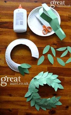 paper plate wreaths and scissors on a wooden table