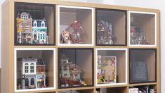 a display case filled with lots of toy figurines on top of wooden shelves