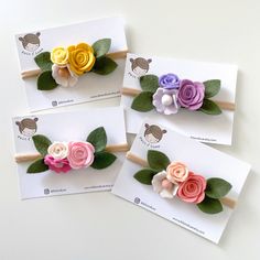 three little flower headbands with leaves and flowers on them, sitting on top of each other