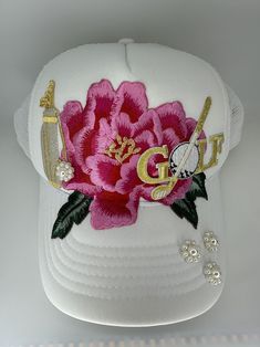 Custom White Trucker Hat- Golf inspired; large pink flower with gold and white gold accents and pearl accessories this hat is ready to ship; i have a large stock of options if customization is needed La Hats Custom, Embellished Trucker Hat, Custom Trucker Hats Patches, Custom New Era Hats, Customizable Trucker Hat, One Size Fits Most, Cute Trucker Hats With Patches, Trucker Hats For Women, Custom Embroidered Trucker Hat, Baseball Cap Style, Fashion Trend Inspiration