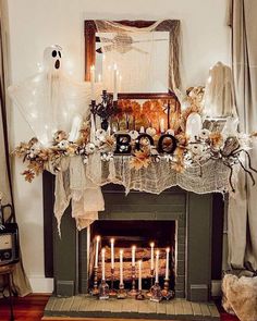 a fireplace decorated with halloween decorations and candles