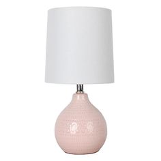 a pink ceramic table lamp with a white shade on the base and a white fabric lampshade