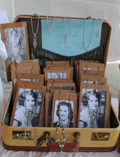 an open suitcase filled with photos and jewelry