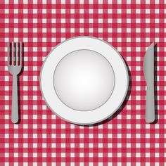 a plate, fork and knife on a red checkered tablecloth with white plates