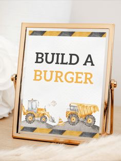 there is a sign that says build a burger and dump trucks are on the table