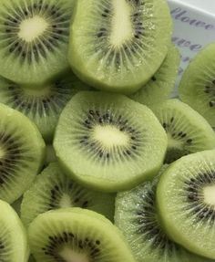 sliced kiwi fruit sitting on top of each other