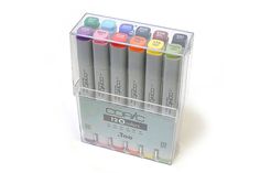 a set of 12 copic markers in a clear box with four different colors on the top