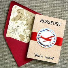 a passport with a red ribbon around it and an airplane badge on the front cover