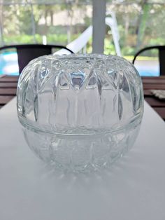 a glass bowl sitting on top of a table