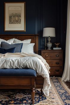 a bedroom with blue walls and white linens on the bed, along with an antique rug