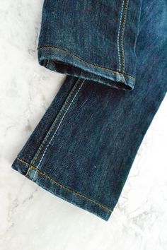 a pair of jeans sitting on top of a white counter