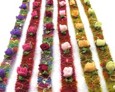 several pieces of fabric with flowers on them are lined up in the shape of strips