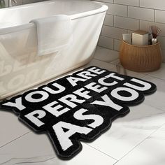 a black and white bathroom rug with the words you are precious