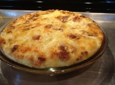 a cheese pizza sitting on top of a metal pan