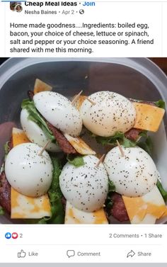 a bowl filled with eggs and bacon on top of lettuce