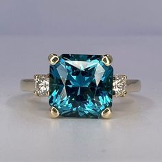 🐕 Big deals! Blue Radiant Cut Engagement Ring With Moissanite Accents in 14K White Gold, London Blue Wedding Ring, Gift For Her #6767 only at $574.00 Hurry. #6767 #SquareStone #GiftForHer #AnniversaryGift #MoissaniteRing #RadiantCut #14kWhiteGold #WeddingRing #EngagementRing #BirthdayGift Square Cut Moissanite Wedding Ring With Center Stone, Radiant Cut Topaz Ring With Prong Setting For Anniversary, Blue Radiant Cut Ring With Prong Setting, Formal Topaz Ring With Moissanite Accent Stones, Formal Blue Topaz Ring With Moissanite, Blue Princess Cut Diamond Wedding Ring, Fine Jewelry Moissanite Radiant Cut Sapphire Ring, Moissanite Topaz Ring With Round Cut Accent Stones, Gia Certified Radiant Cut Sapphire Ring Gift