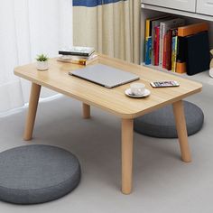 a wooden table with a laptop on top of it