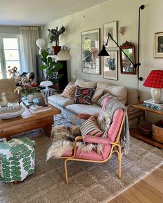 a living room filled with furniture and pictures on the wall