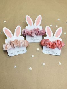 three little bunnies with pink bows on them