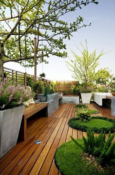 a wooden deck with planters and benches