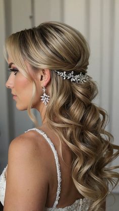 a woman with long blonde hair wearing a wedding hairstyle