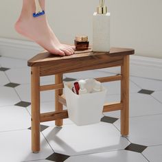 a woman's feet on a stool with cosmetics and other items