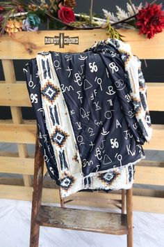 a blanket sitting on top of a wooden chair