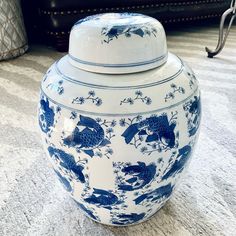 a blue and white vase sitting on the floor