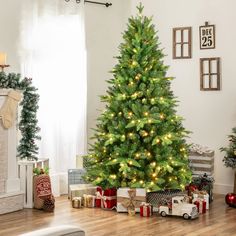 a decorated christmas tree in a living room with presents on the floor next to it