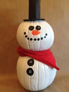 a snowman made out of pumpkins sitting on top of a table