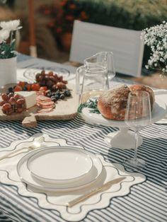 the table is set with bread and grapes