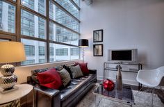 a living room filled with furniture and a flat screen tv on top of a wall