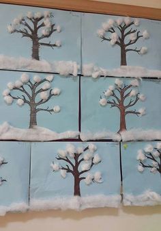 snow covered trees are arranged in squares on the wall