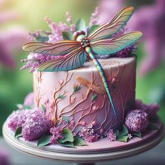 a cake decorated with flowers and a dragon on top is sitting on a plate in front of purple flowers